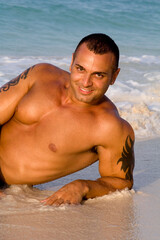 Tanned Male Model Lying Down on Beach