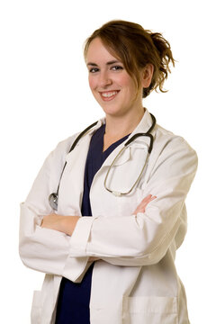 Attractive friendly smiling young lady doctor in white lab coat with a stethoscope standing on white