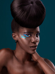Portrait, cosmetics and hair care with an african woman in studio on a blue background for beauty or makeup. Eyeshadow, hairstyle and fashion with an attractive young female model at the salon