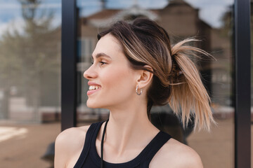 Close-up portrait shot of a young blonde business lady with a hair claw in her straight hair. Woman...