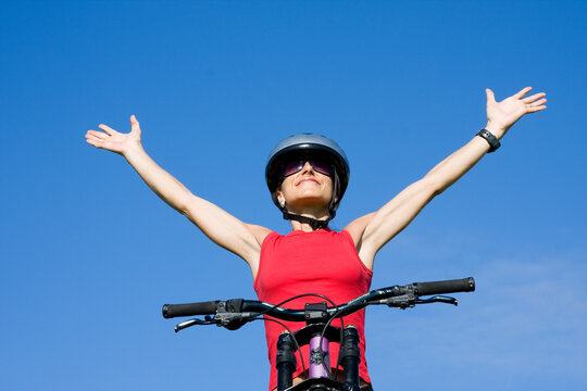 Beutiful women with her arms outstretched isolated on blue sky