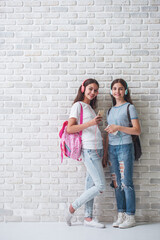 Obraz na płótnie Canvas Attractive teenage girls with gadgets