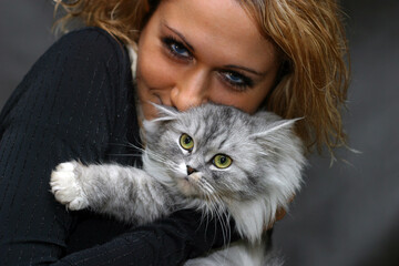 Portrait of the beautiful girl with cat