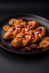 Delicious fresh crispy pastry in the form of a pigtail with strawberries and blueberries