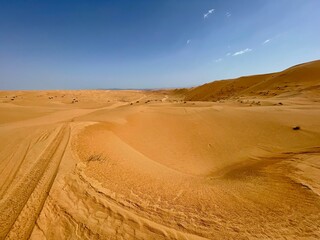 Fototapeta na wymiar Panoramic view of the desert sand dunes of Wahiba in Oman 