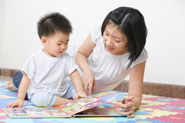 Fototapeta premium Asian mother tutoring her son for early education