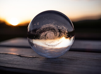 crystal ball with Galaxy Milky Way at sunset.