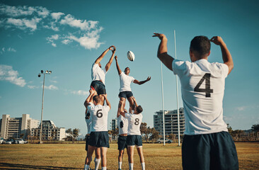 Team, rugby and jump or lift, ball and teamwork or sport, training for game and fitness, exercise or sports performance with blue sky. Group, men and lifting man to catch and professional match - obrazy, fototapety, plakaty