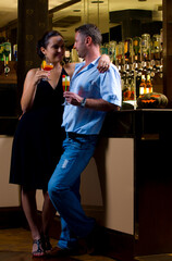 Portrait of young attractive couple having date in bar
