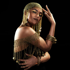 African woman, portrait and gold fashion with beauty and cosmetics in a studio. Isolated, black background and young female face with crown, Egypt jewelry and culture empowerment with queen pride