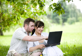 happy young couple relaxing in park