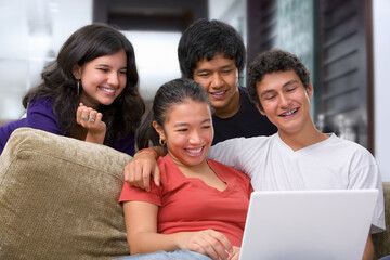 Obraz premium Teenagers watching something interesting on laptop at home.