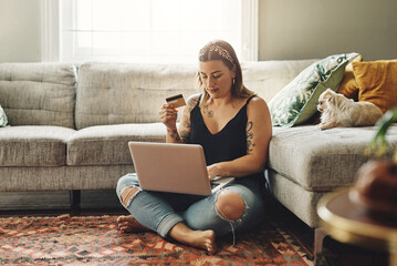 Laptop, credit card and woman in home online shopping, ecommerce and fintech application, loan or finance on floor. Gen z person typing, banking or website on computer, digital payment or transaction