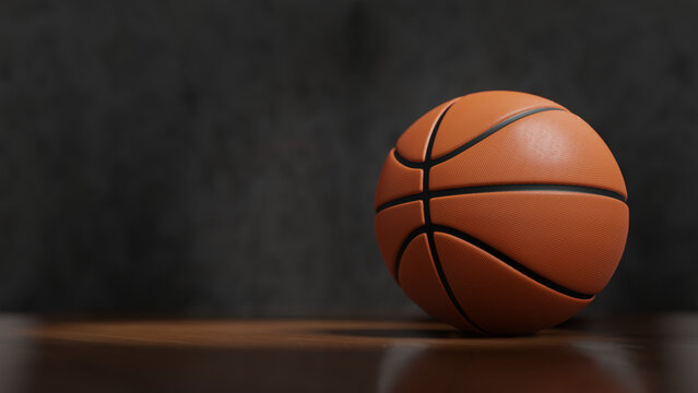 Perspectiva dramática de uma bola laranja de basqueteball com fundo escuro para layouts ou fundos esportivos