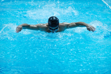 young healthy with muscular body man swim on swimming pool and representing healthy and recreation concept