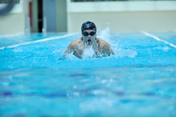 young healthy with muscular body man swim on swimming pool and representing healthy and recreation concept