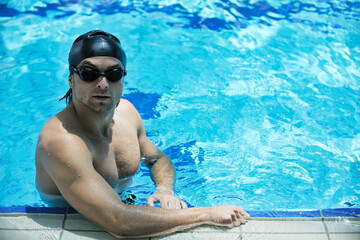 young healthy with muscular body man swim on swimming pool and representing healthy and recreation concept