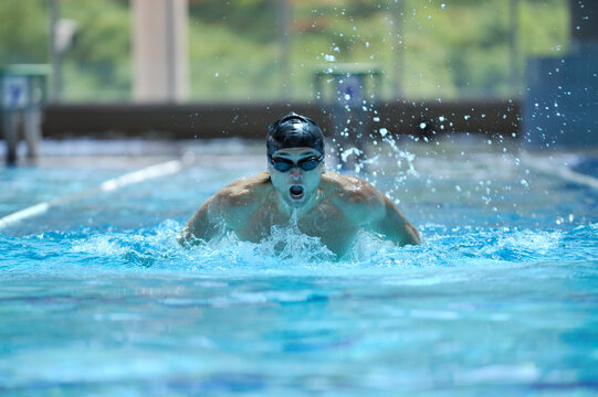 young healthy with muscular body man swim on swimming pool and representing healthy and recreation concept