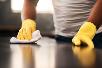 Man hands, cleaning gloves and wipe on a table with a wash cloth and housekeeping. Home, countertop...