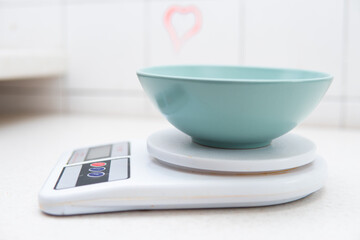 a bowl on a kitchen scale. Weighing food