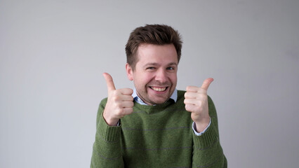 The European young man gives a thumbs up, approving the choice