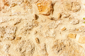 Background. Wall made of raw stone. The wall is made of uncut stones.