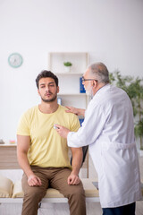 Young male patient visiting old male doctor