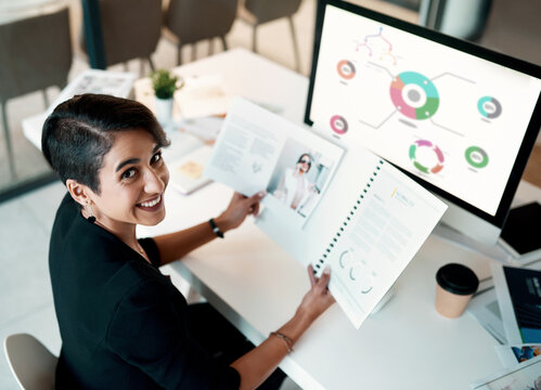 Portrait, woman and computer screen for data analytics, documents and planning ecommerce or fashion business. Happy face of creative designer or person, paperwork and analysis, charts or graphs above - Powered by Adobe