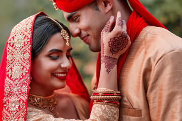 Wedding, marriage and hand henna with couple together in celebration of love at a ceremony. Happy,...