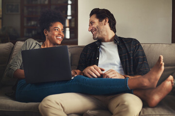 Laptop, relax and an interracial couple streaming a movie using an online subscription service for...