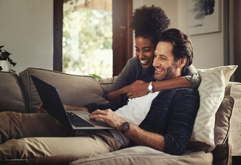 Laptop, subscription and an interracial couple watching a movie using an online streaming service...