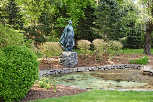 Pilgrim Maiden statue next to her pond in Brewster Gardens. Plymouth, MA.