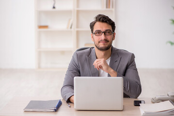 Young male employee working in the office