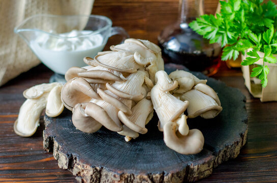 Fresh oyster mushrooms on a wooden board on the table