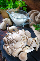 Fresh oyster mushrooms on a wooden board on the table