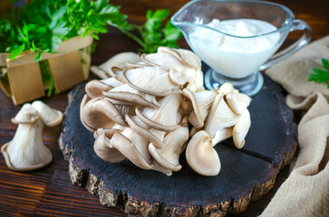 Fresh oyster mushrooms on a wooden board on the table