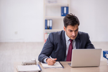 Young male employee working in the office