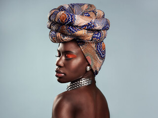 Black woman, profile and African turban, fashion and beauty with makeup isolated on studio...