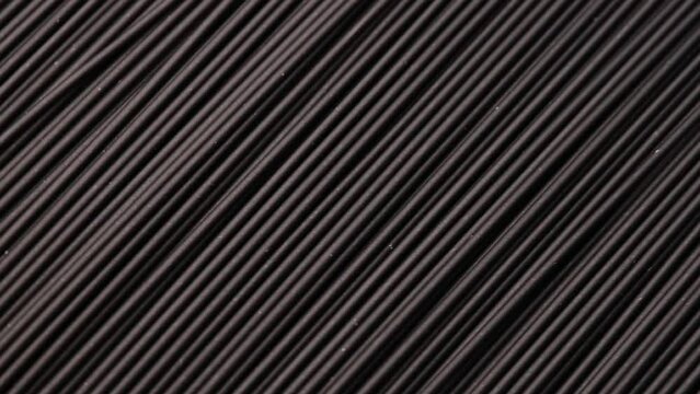 black spaghetti, rotation in circle. black abstract background, Turning. selective focus. spaghetti nero di seppia