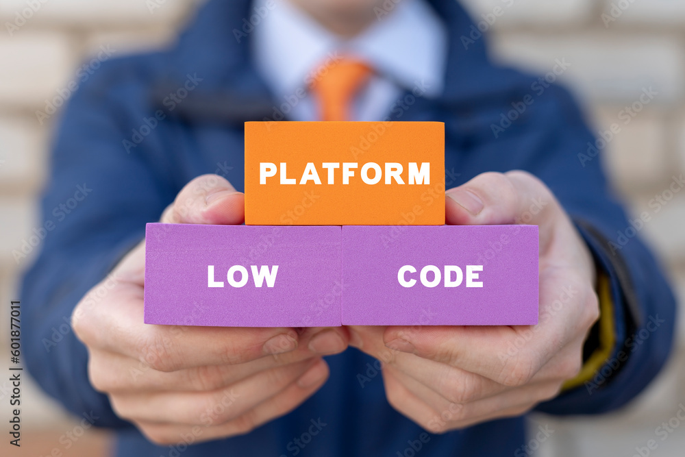 Poster businessman holding colorful blocks with inscription: low code platform. concept of low code softwar