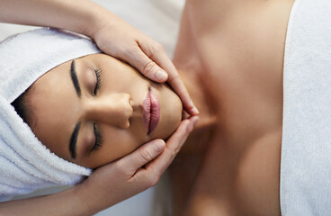Obraz na płótnie Canvas Woman, hands and face in relax for massage, skincare or beauty spa treatment on bed above at resort. Top view of female relaxing with eyes closed for calm therapy, healthy wellness or cosmetic facial