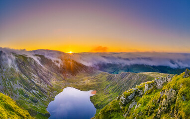 Amazing sunrise above misty mountains from Cadair Idris, Snowdonia, North Wales