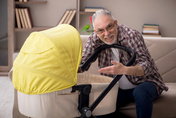 Old man looking after newborn at home