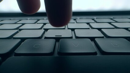 A program coder is typing on laptop keyboard close up macro. Hacker is using computer. Man hands are searching in web or working on pc. Concept of digital cyber security and vpn data protection