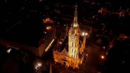 Fototapeta na wymiar Establishing Aerial View Shot of Matthias church and Fishermans Bastion at night. Budapest, Hungary