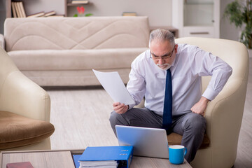 Old male boss working from home during pandemic