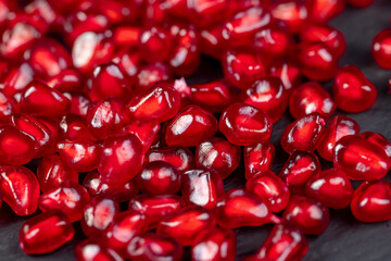 Grains of red ripe pomegranate close up