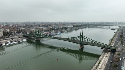 Fototapeta na wymiar Aerial view of Budapest Szabadsag hid (Liberty Bridge or Freedom Bridge), connects Buda and Pest across the River Danube. A tram circulates