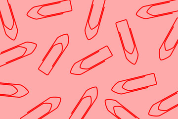 Business office pattern. A pile of red paper clips scattered on a red background	