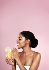 Woman, healthy orange juice and smile in studio, pink background and mockup for vitamin c benefits....